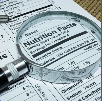 Magnifying glass over a biscuit Nutrition Facts label, with serving size and nutrient rows visible.